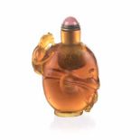 A CHINESE AMBER PEKING GLASS SNUFF BOTTLE carved with a long-bodied 'Chilong' coiling through the