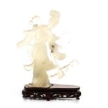 A CHINESE CARVED JADEITE FIGURE OF A MAIDEN in stride, gazing down at a fan held in her left hand,