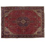 A TABRIZ CARPET, NORTH WEST PERSIA, MODERN the red field with a blue and ivory floral medallion,