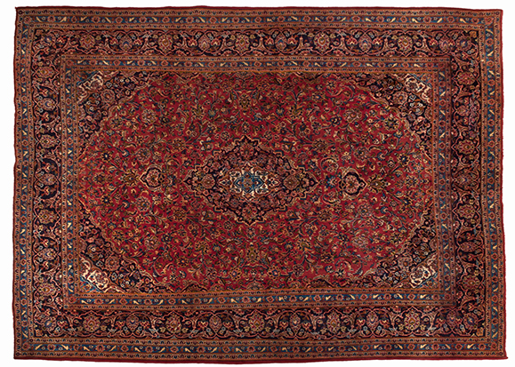 A KESHAN CARPET, PERSIA, MODERN the madder-red field with an indigo-blue floral medallion, similar