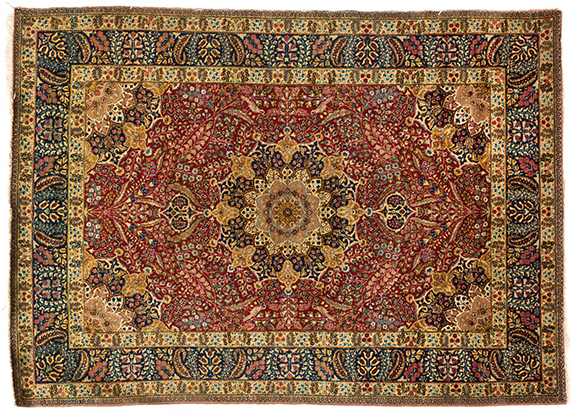 A TABRIZ RUG, PERSIA, CIRCA 1950 the red field with a blue and gold floral star medallion, similar
