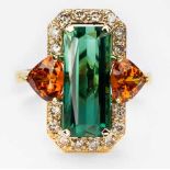 A GREEN TOURMALINE, DIAMOND AND MANDARIN GARNET RING centered with a rectangular scissors-cut