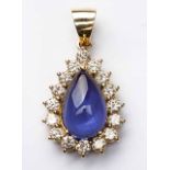 A TANZANITE AND DIAMOND PENDANT centred with a pear-shaped cabochon tanzanite weighing 6.55cts,