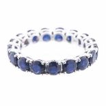 A SAPPHIRE ETERNITY RING claw-set throughout with circular mixed-cut sapphires weighing