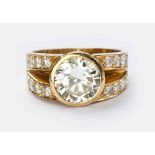 A DIAMOND RING centred with a bezel-set round brilliant-cut diamond weighing approximately 2.