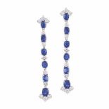 A PAIR OF SAPPHIRE AND DIAMOND PENDANT EARRINGS each designed as an articulated line of oval mixed–