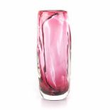 A DARK PINK COLOURED GLASS VASE, MODERN the cylindrical shaped body with white threads, signed,