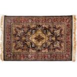 AN EGYPTIAN SILK RUG, MODERN the deep indigo-blue field with an ivory floral medallion, similar