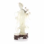 A CHINESE CARVED JADEITE FIGURE OF A MAIDEN standing, looking down in contemplation holding a fan in