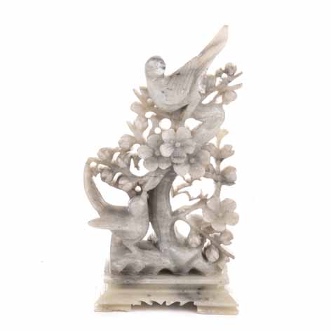 A CHINESE CARVED HARDSTONE 'BIRD AND PRUNUS' GROUP of triangular form rising from a shaped