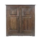 AN ENGLISH OAK CUPBOARD, 19TH CENTURY the rectangular outswept top above a pair of panelled doors