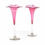 A PAIR OF VICTORIAN CRANBERRY STEM VASES each in the form of a tubular flowerhead, with shaped rim