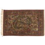 A QUM SILK RUG, PERSIA, MODERN the ivory field with large polychrome leaf design, all with