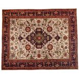 A TABRIZ CARPET, NORTH WEST PERSIA, MODERN the ivory field with a geometric blue medallion, all with