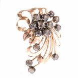 AN 18CT GOLD BROOCH of floral spray design, embellished with circular cabochon black stones,