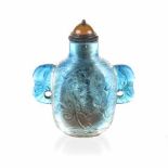 A CHINESE SKY BLUE PEKING GLASS SNUFF BOTTLE each side similarly carved with a 'Chilong' above waves