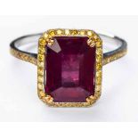 A RUBY AND DIAMOND RING centred with an emerald step-cut ruby weighing 4.14cts, within a surround of