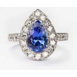 A TANZANITE AND DIAMOND RING centred with a pear-shaped mixed-cut tanzanite weighing 2.631cts, the