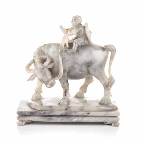 A CHINESE CARVED HARDSTONE 'BOY AND BUFFALO' GROUP the child astride a buffalo, gripping onto a rope