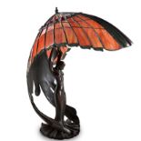 A THREE-LIGHT TIFFANY STYLE TABLE LAMP, 20TH CENTURY the curved shade above an support in the form