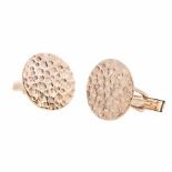 A PAIR OF 9CT GOLD CUFFLINKS each of circular form with textured, circular indentations, with hinged