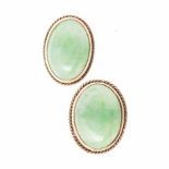A PAIR OF JADE-LIKE EAR STUDS each centred with an oval cabochon jade-like stone, within a
