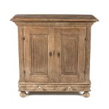 A DUTCH OAK LOW CUPBOARD, 19TH CENTURY the rectangular moulded top above an outset pediment, a