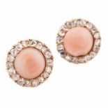 A PAIR OF GEM AND DIAMOND EAR STUDS each centred with a cabochon pink gem, possibly coral, within