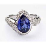 A TANZANITE AND DIAMOND RING centred with a pear-shaped tanzanite weighing approximately 2.70cts,