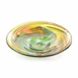 A GREEN, AMBER AND WHITE GLASS DISH, MODERN of circular shape, signed, numbered 02/1039, distress