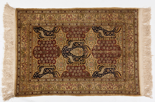 A HEREKE SILK RUG, TURKEY, MODERN the field with overall cartouches in red, blue and ivory, each