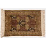 A HEREKE SILK RUG, TURKEY, MODERN the field with overall cartouches in red, blue and ivory, each