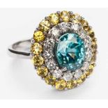 A BLUE ZIRCON, DIAMOND AND YELLOW SAPPHIRE RING centred with an oval step-cut blue zircon weighing