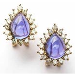 A PAIR OF TANZANITE AND DIAMOND EAR STUDS each centred with a pear-shaped cabochon tanzanite