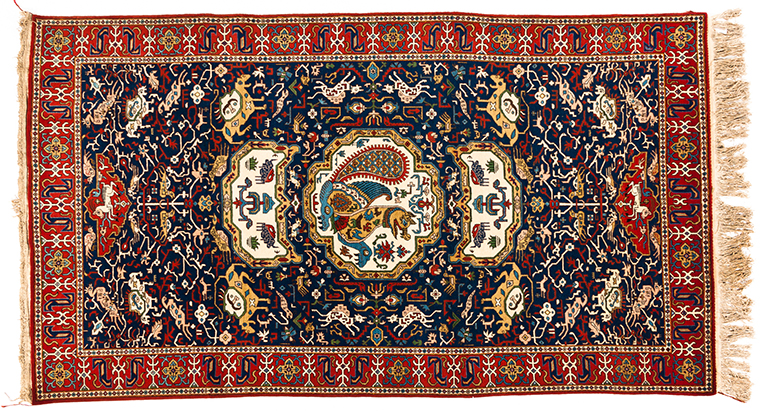 A QUM RUG, PERSIA, MODERN the indigo field with an ivory pictorial medallion and pendant, all with