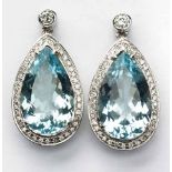A PAIR OF AQUAMARINE AND DIAMOND PENDANT EARRINGS each centred with a pear-shaped aquamarine