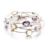 FOUR SILVER AND GEMSTONE BANGLES each bangle tube-set with various gemstones including: amethyst,