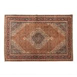 A KURDI CARPET, WEST PERSIA, MODERN the madder-red field with an ivory and blue floral medallion,