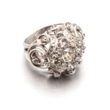 A DIAMOND CLUSTER RING centred with a round brilliant-cut diamond weighing approximately 0.54cts,