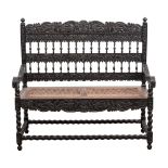 AN EBONY BENCH, 19TH CENTURY the shaped, foliate carved top, mid and bottom rails joined by turned