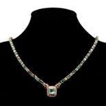 AN EMERALD AND DIAMOND NECKLACE centred with a claw-set emerald-cut emerald weighing approximately