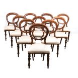A SET OF TEN VICTORIAN WALNUT BUSTLE-BACK SIDE CHAIRS each moulded top and bottom rail on square-