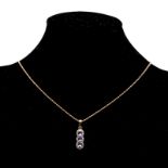 A TANZANITE AND DIAMOND PENDANT designed as a line of three oval mixed-cut tanzanite's weighing