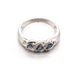 A SAPPHIRE AND DIAMOND RING centred with a twist design, set with three marquise-cut sapphires
