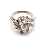 A DIAMOND RING in the form of a flower, centred with a round brilliant-cut diamond weighing