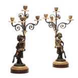 A PAIR OF PATINATED BRONZE FIGURAL CANDELABRAS, CIRCA 1900 each depicting a baby satyr supporting