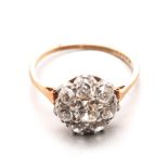 A DIAMOND CLUSTER RING centred with an old-cut diamond weighing approximately 0.28cts, within a