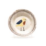 HYLTON NEL (1941-): A TIN-GLAZED EARTHENWARE PLATE the centre painted with a stylised bird