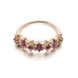 A RUBY AND DIAMOND RING set to the centred with flower heads composed of marquise- and circular-