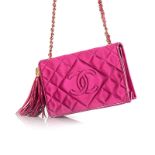 A VINTAGE CHANEL QUILTED SATIN HANDBAG of fuchsia colour, edged in leather with gold metal hardware,